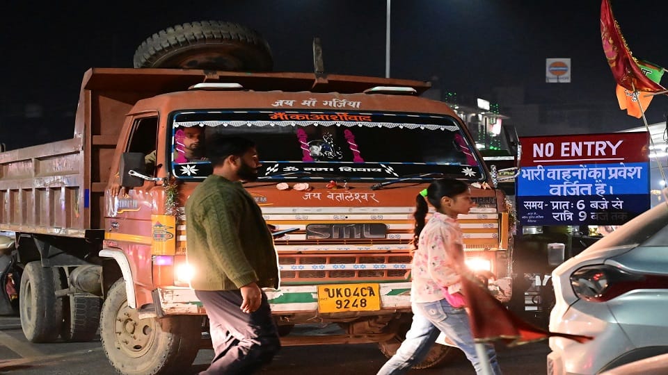 Heavy vehicles passing in front of no entry board in haldwani