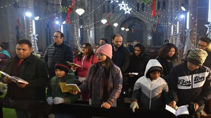 Happy Christmas: Church bells ring during midnight service, churches illuminated with candlelight