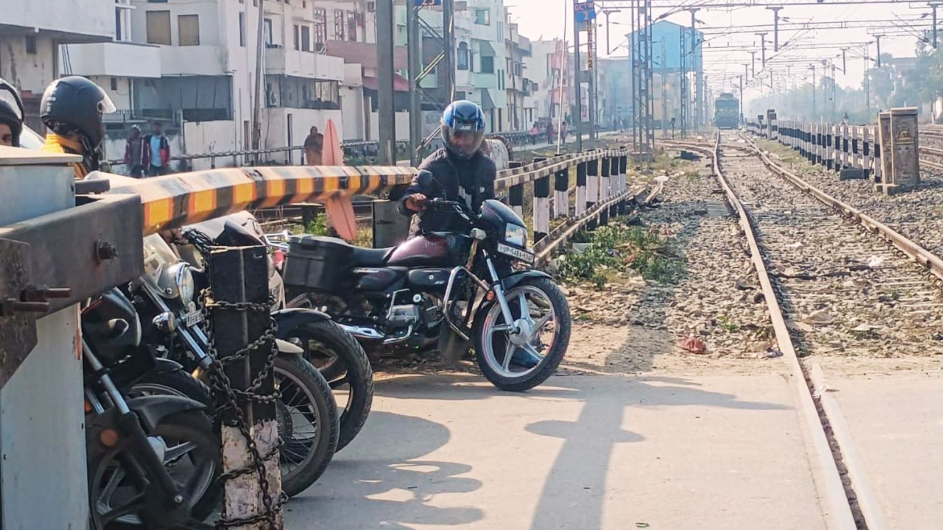 People crossing railway tracks going under boom barriers rules being ignored at station in ghazipur