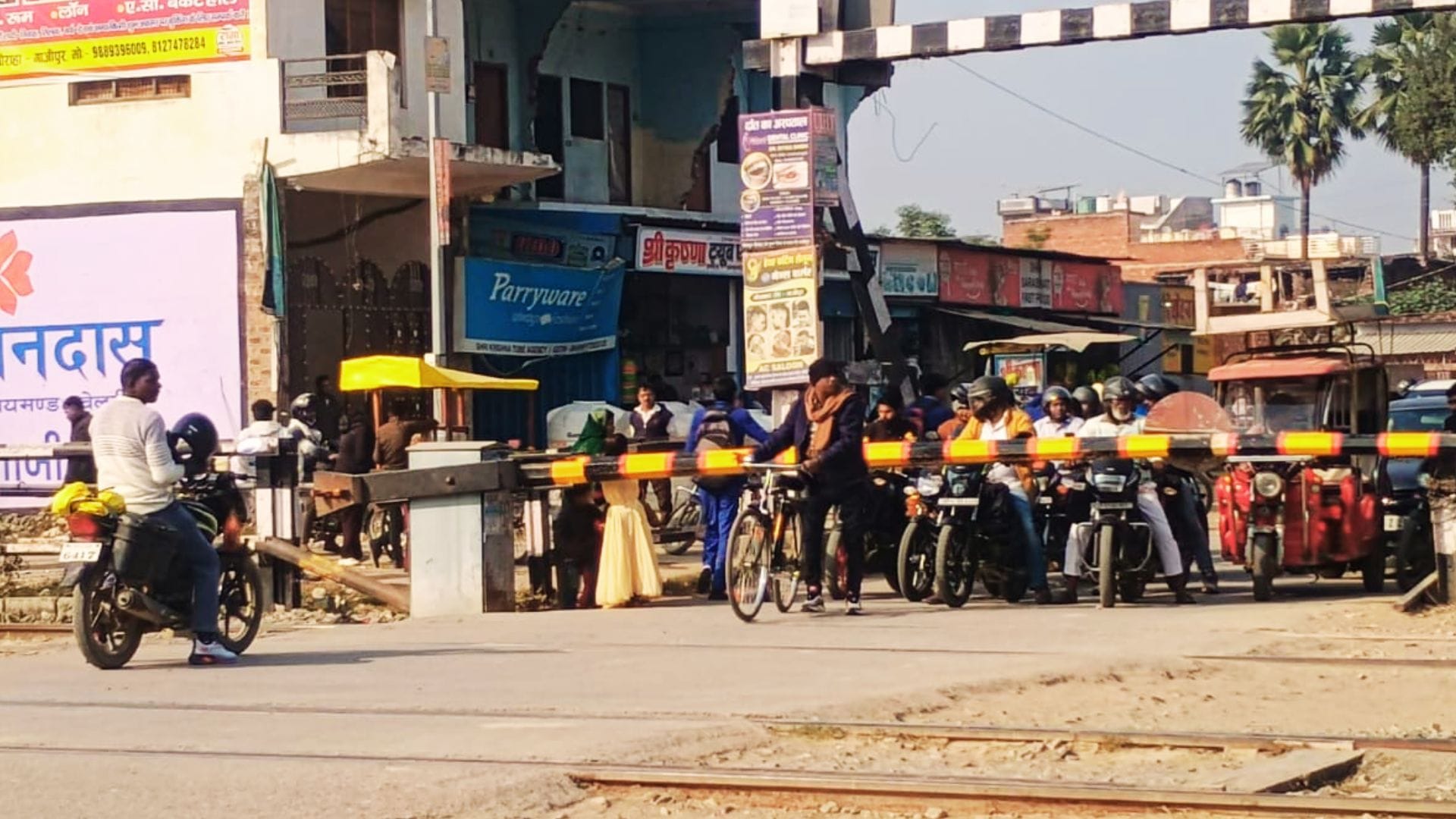 People crossing railway tracks going under boom barriers rules being ignored at station in ghazipur