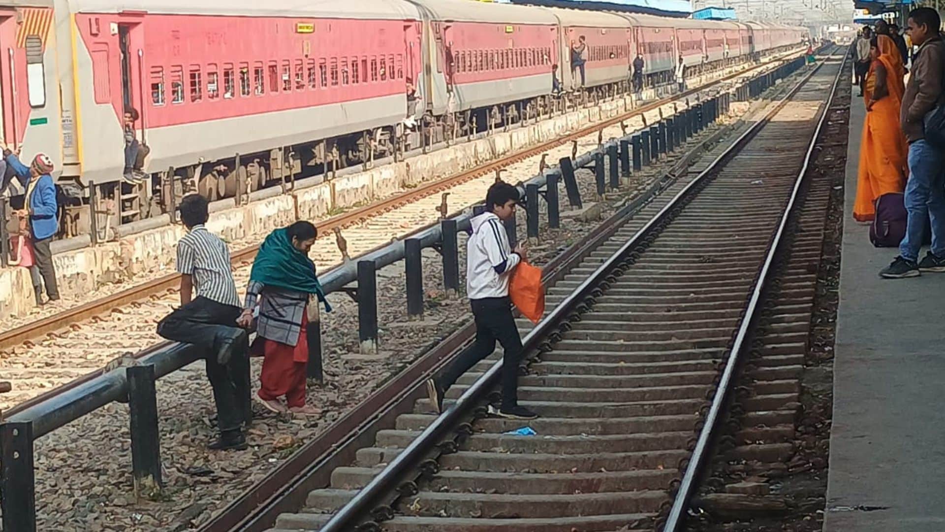 People crossing railway tracks going under boom barriers rules being ignored at station in ghazipur