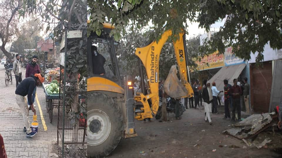 अलीगढ़ रोड पर पीली रेखा खींची, वहां से अतिक्रमण हटाती जेसीबी