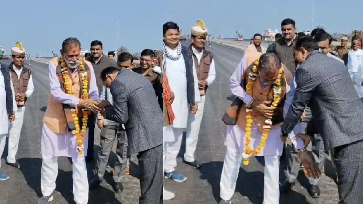 Lalitpur: Yogi's minister garlands the Divisional Commissioner and tries to touch his feet.