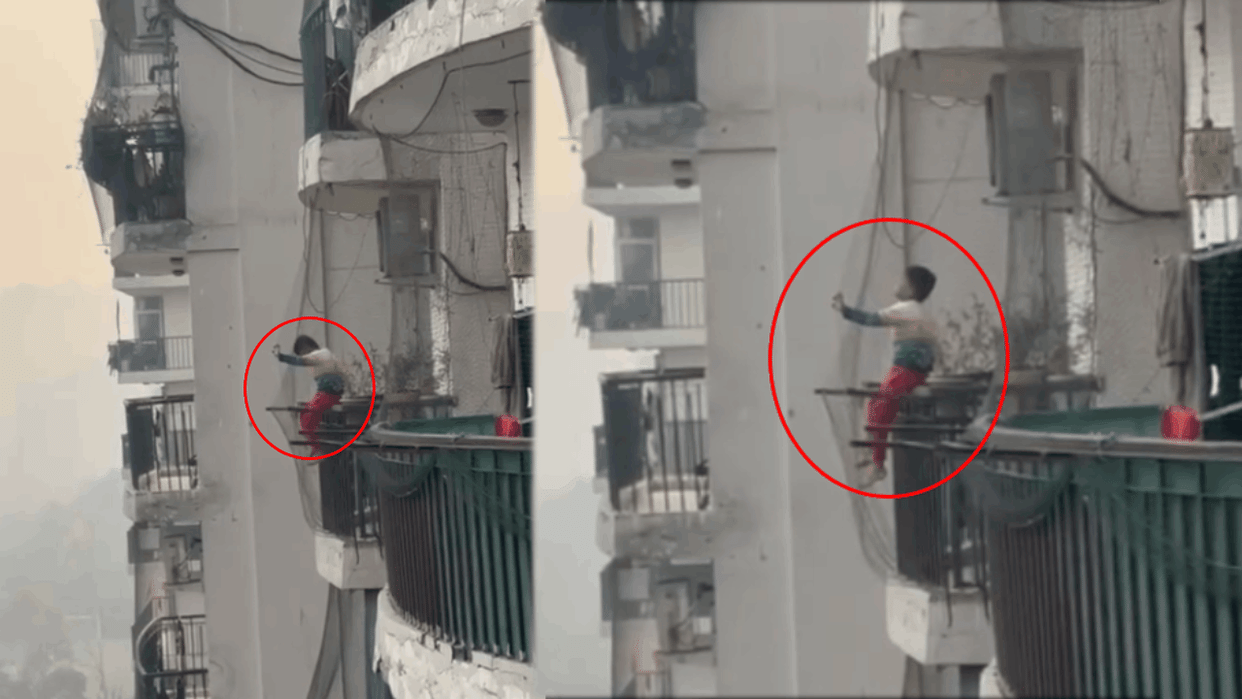 child was sitting on balcony railing of sixth floor video viral