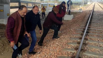 school surrounded by two railway tracks