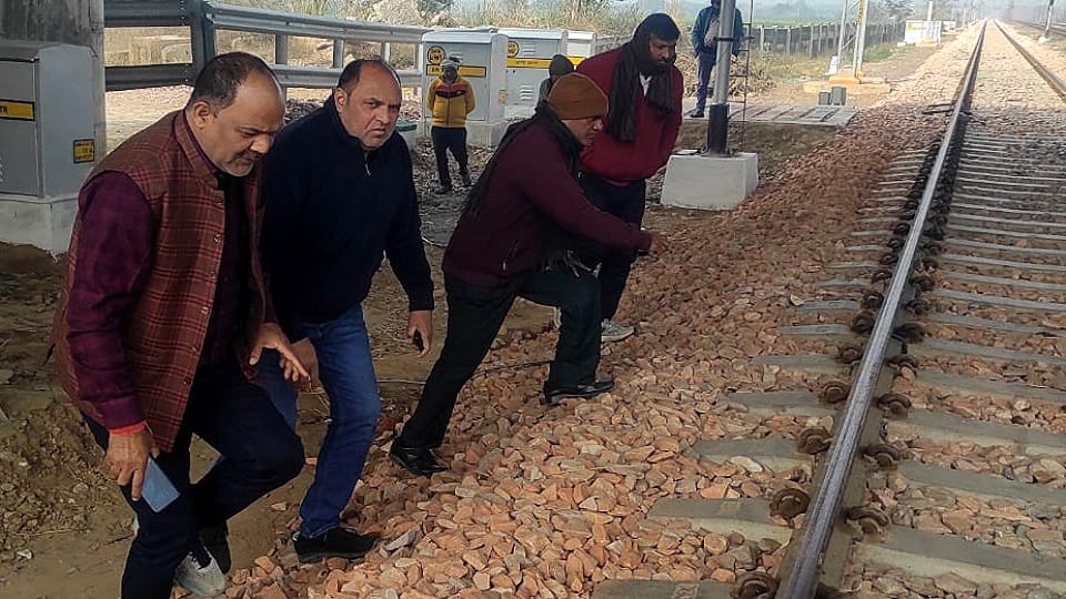 school surrounded by two railway tracks