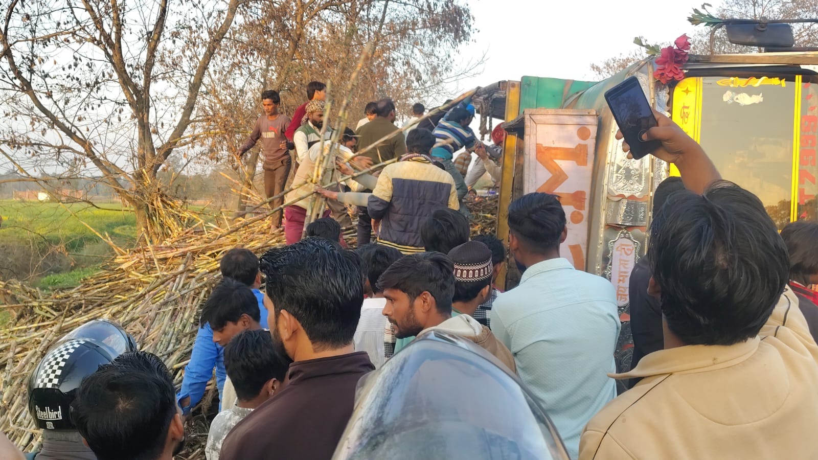 Sugarcane loaded truck overturns on car on Pilibhit highway several feared trapped