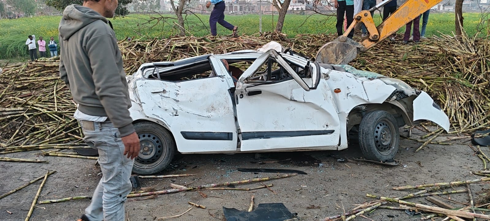 Sugarcane overloaded truck overturns on car police officer recovers safely after an hour
