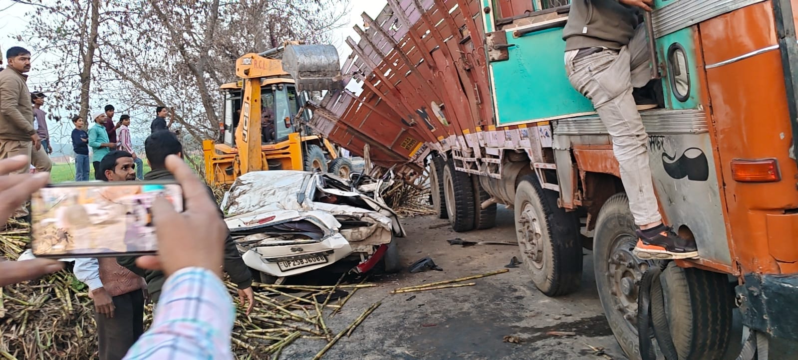 Sugarcane overloaded truck overturns on car police officer recovers safely after an hour