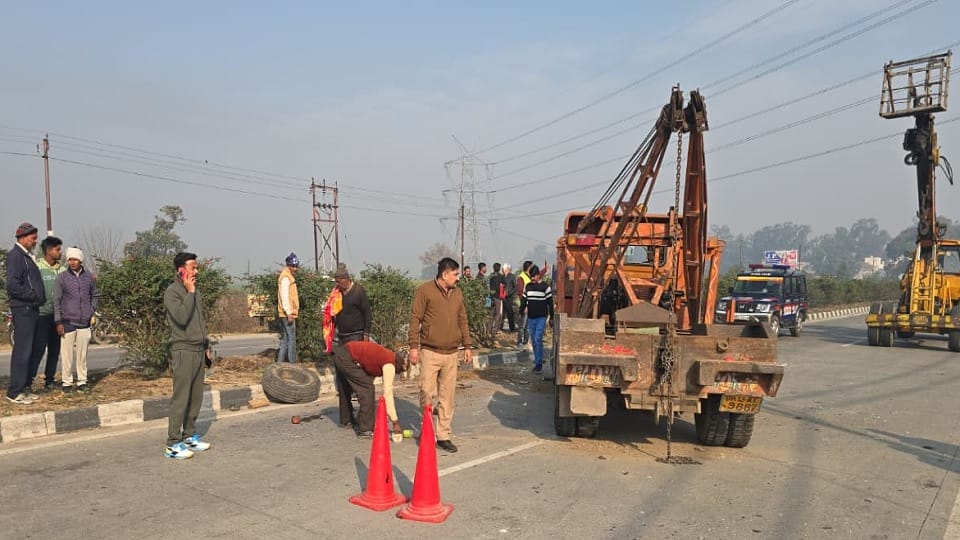 Truck and crane overturned in a roadside ditch after being hit by a bus, two injured