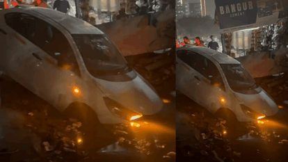 Parked car skids and falls into drain and no one injured