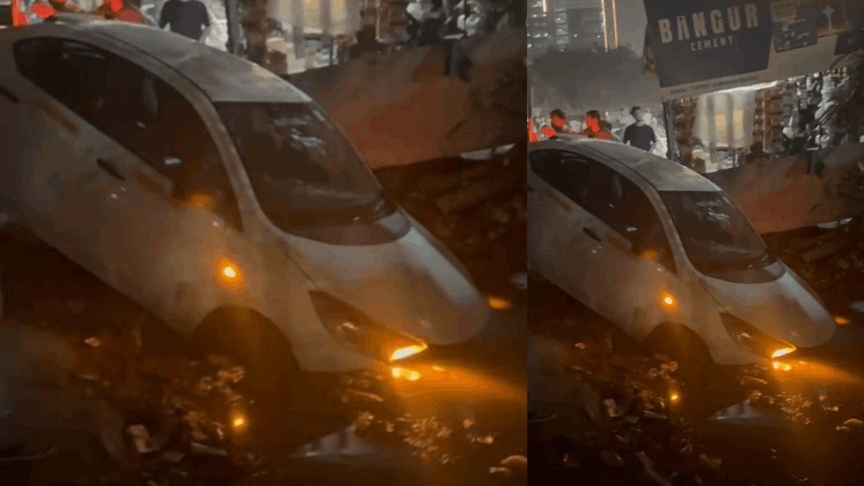 Parked car skids and falls into drain and no one injured