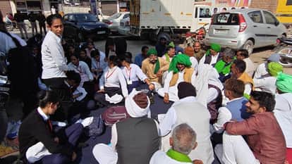 Students sit outside MLA's residence in Hansi, protesting against not getting migration certificate
