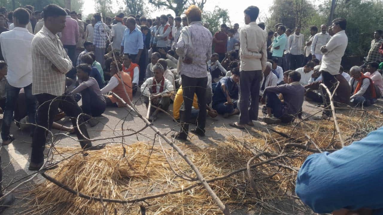 सड़क पर बैठे किसान।