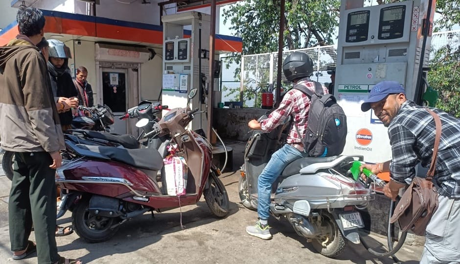 People filled their vehicle tanks at a petrol pump in Almora