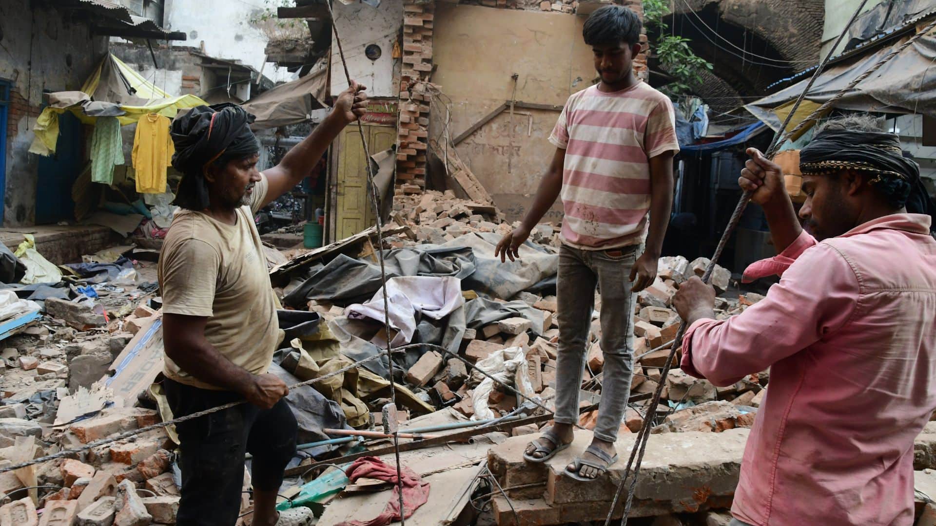 Buildings in Dal Mandi demolished using bulldozers chisels and hammers in varanasi