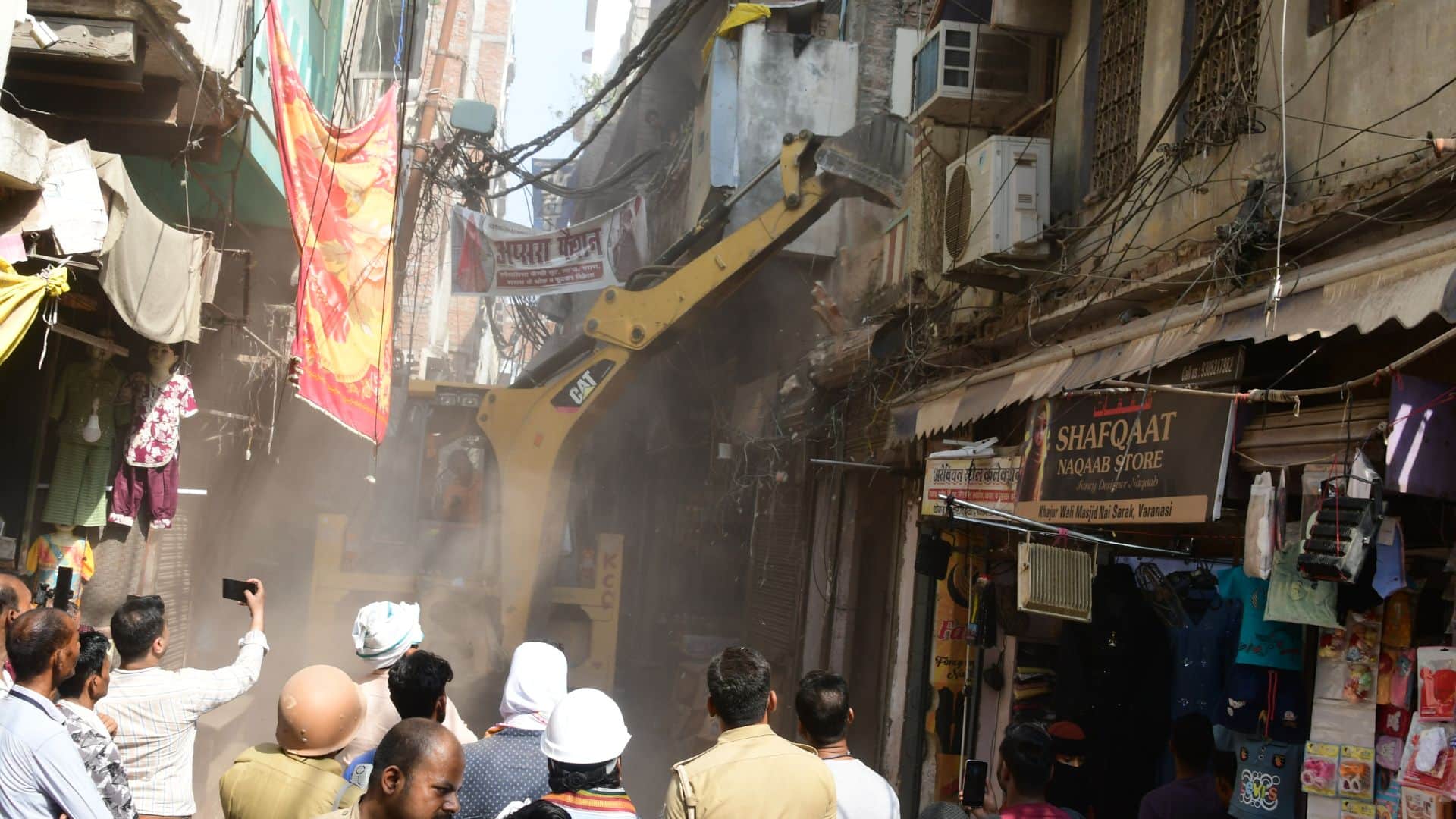 Buildings in Dal Mandi demolished using bulldozers chisels and hammers in varanasi