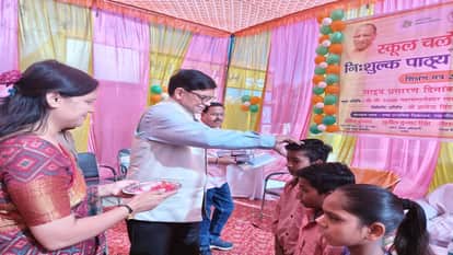 Children read newspapers in schools during the new academic session