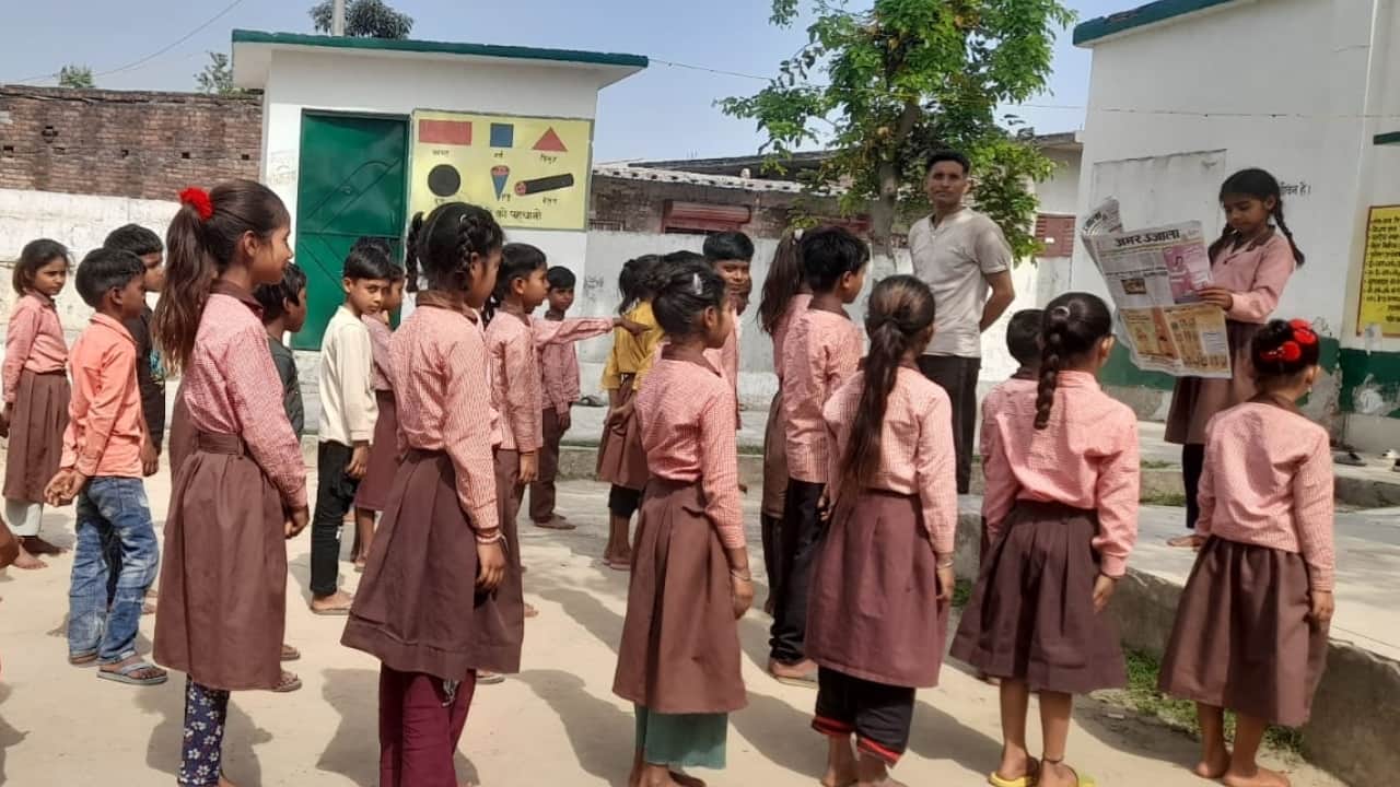 भारत-नेपाल सीमा के समीप डांगा प्राथमिक विद्यालय में अमर उजाला अखबार पढ़ती छात्रा।