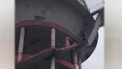 intoxicated man climbed atop water tank with innocent child strapped to his back In Sitapur