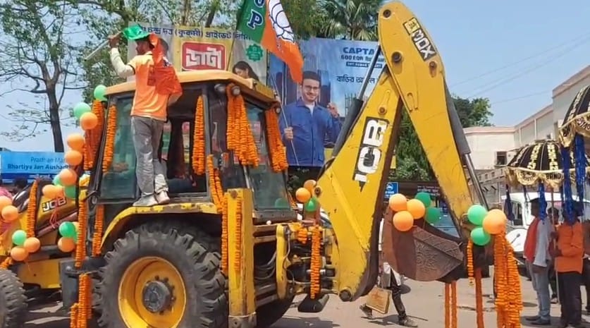 Bengal polls 2026 : BJP candidate rides bulldozer to file his nomination