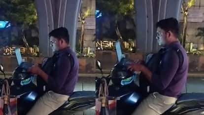 Man working on his laptop a bike on the road at midnight office pressure video goes viral