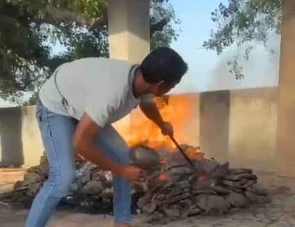 Lighting Hookah with Fire from Burning Funeral Pyre in hapur