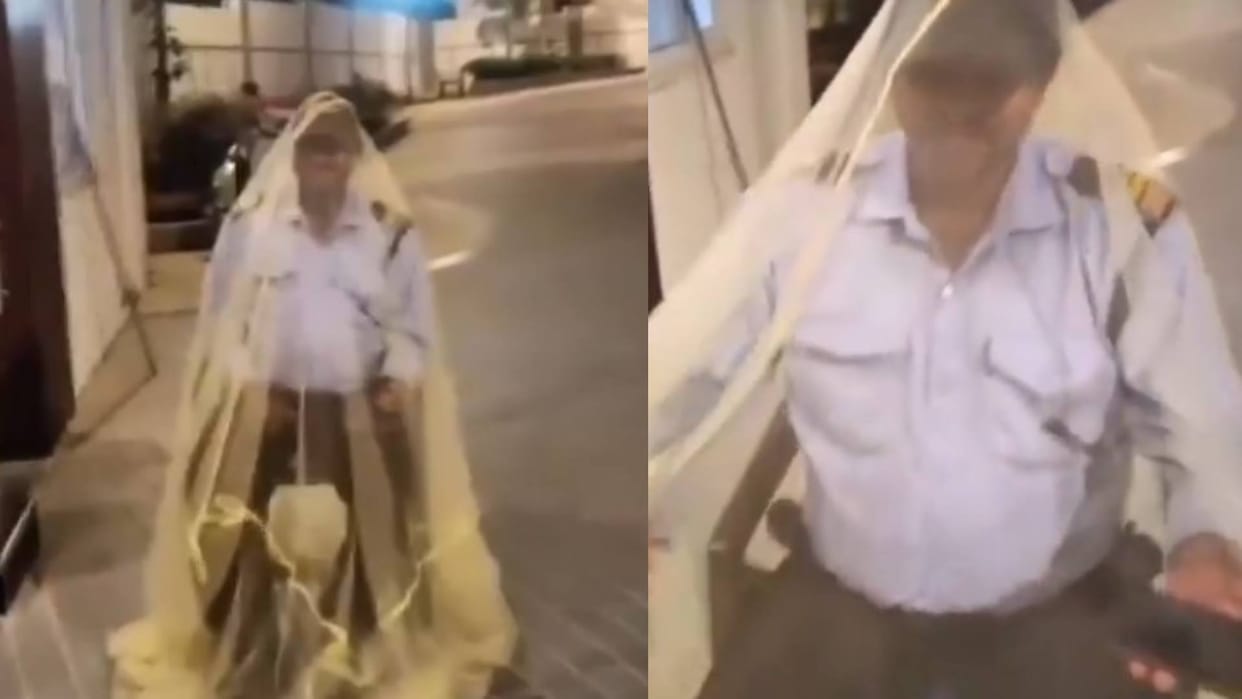 viral video security guard performs duty under mosquito net in hyderabad