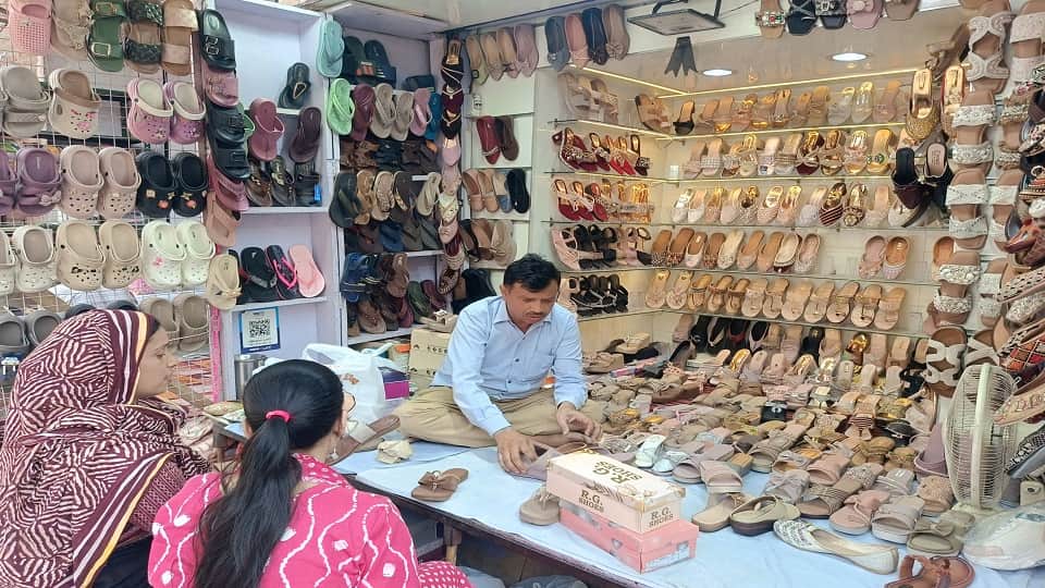 शहर की एक दुकान पर फुटवियर्स खरीदते ग्राहक