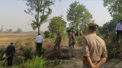 A woman's charred body was found in a field in Maharajganj, with wounds on her body.