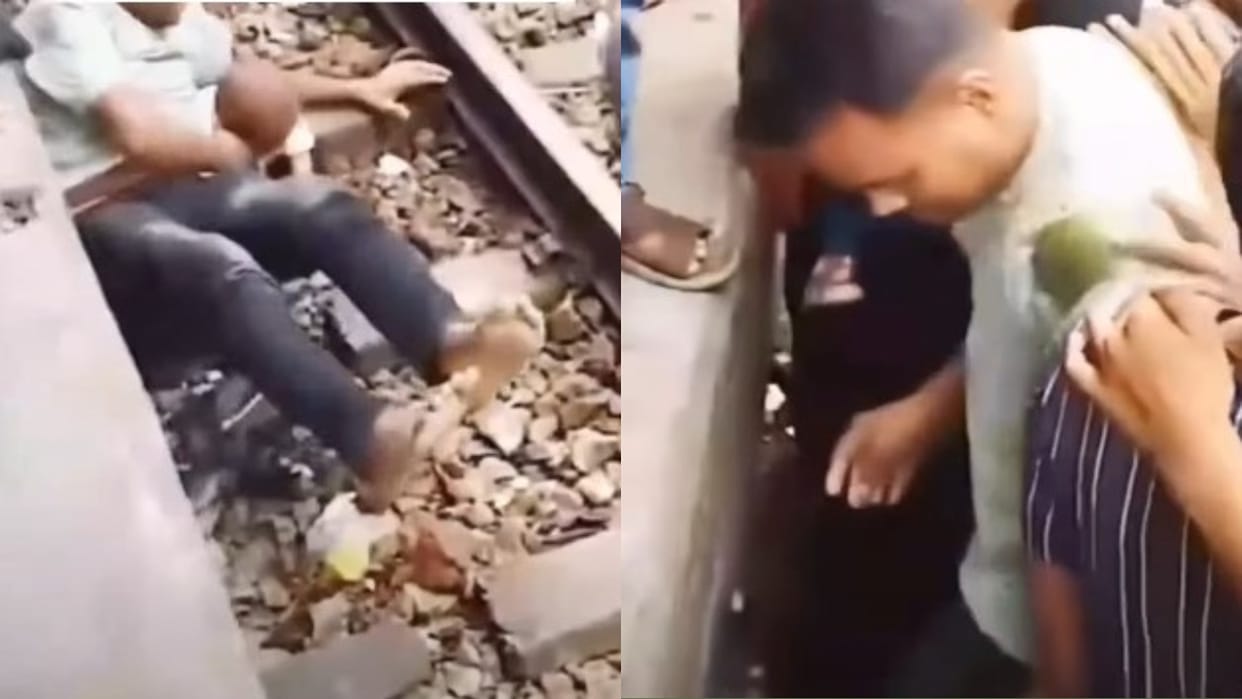 Bangladesh viral video Father rescues child who fell on railway tracks from under moving train