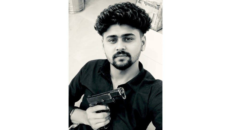 Photo of a young man holding a pistol