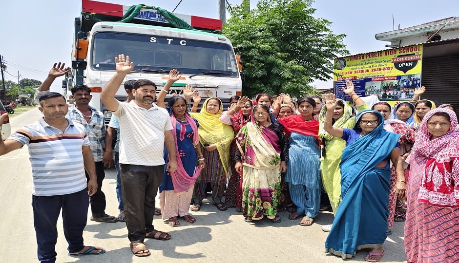 Women stood in front of overloaded dumpers, blocking the way