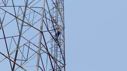 youth creates scene by climbing a mobile tower after girlfriend marriage is fixed with another man in Budaun