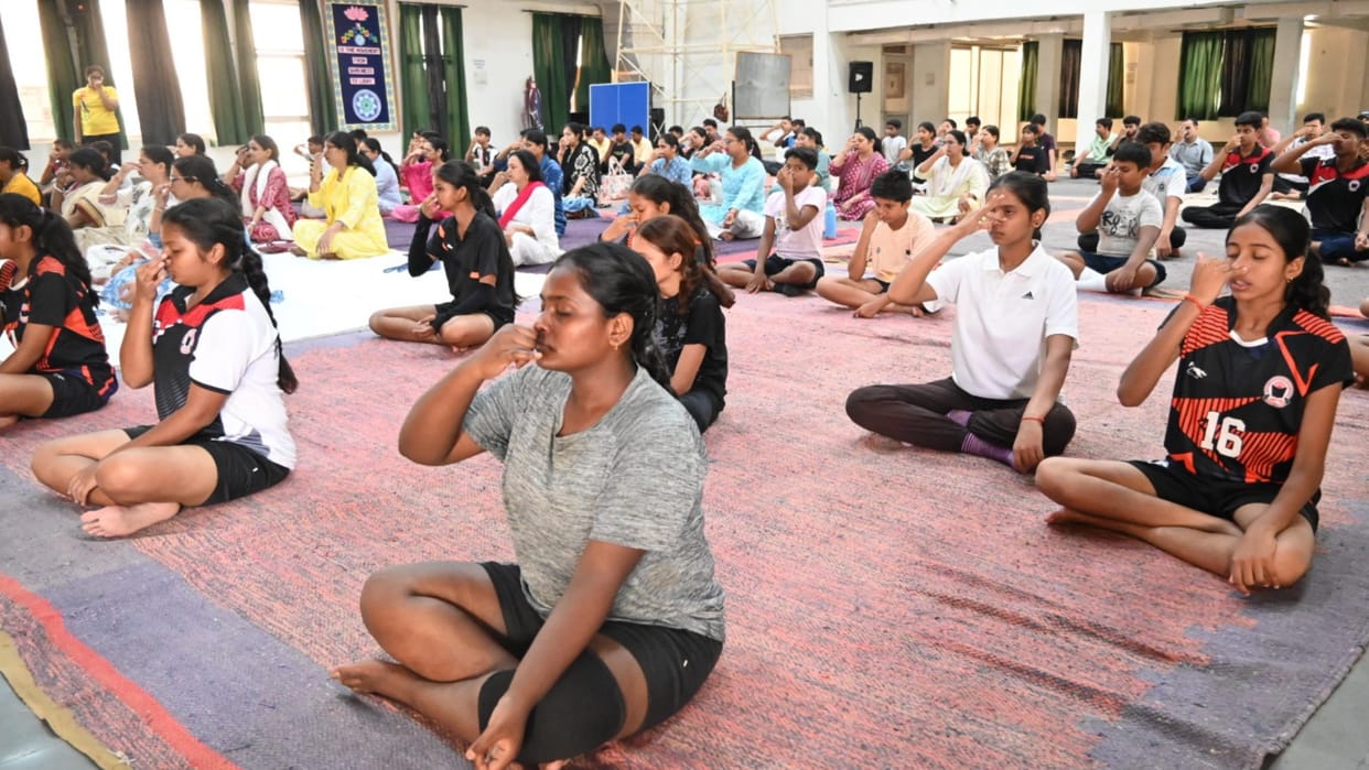 A camp was organized at Patanjali Nursery School on Yoga Day; children practiced yoga.
