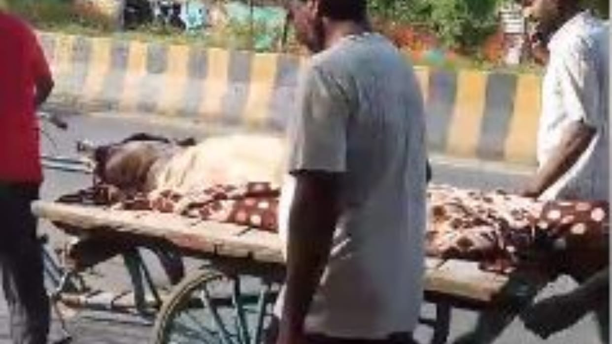 No ambulance available relatives took elderly patient to private hospital on a handcart