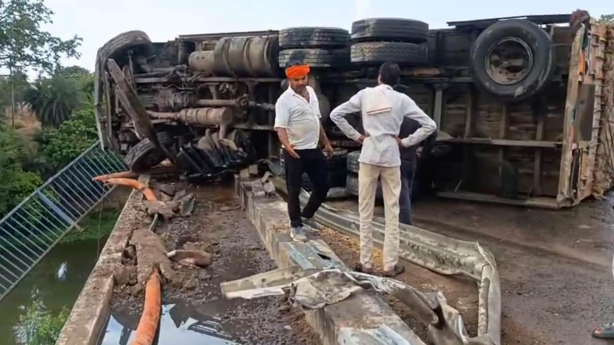 Lalitpur: Truck overturns on highway after colliding with a pickup and crashing through bridge railing