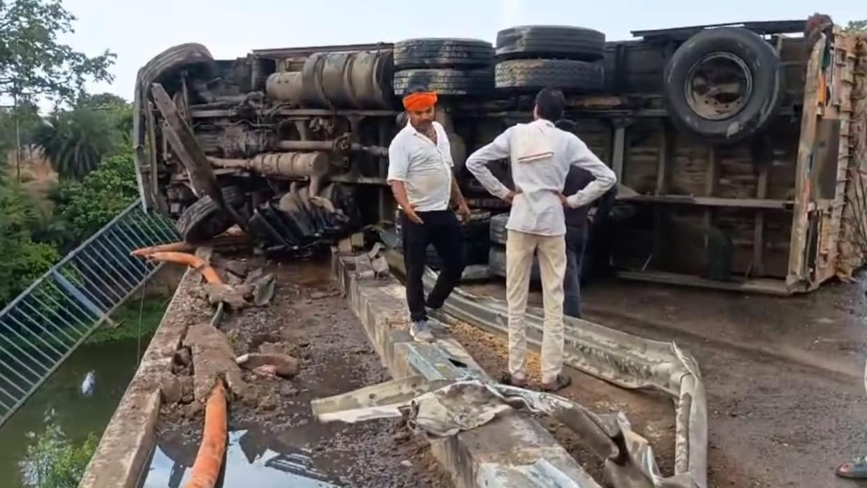 Lalitpur: Truck overturns on highway after colliding with a pickup and crashing through bridge railing