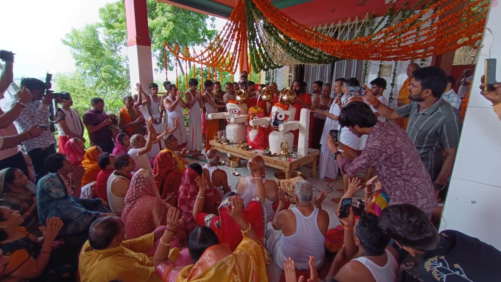 भगवान के पूजन के अवसर पर मौजूद भक्त
