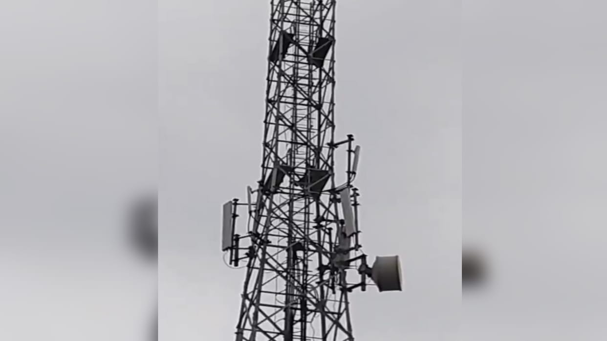 Teenager stays atop mobile tower for seven hours, demanding the release of a teenage girl.