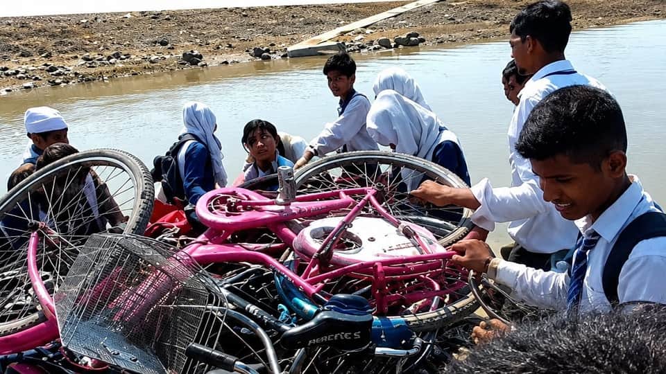 The children of Kopa have to cross the river every day