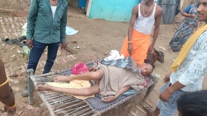 Elderly man carried on cot after venomous insect bite as muddy road blocks ambulance access