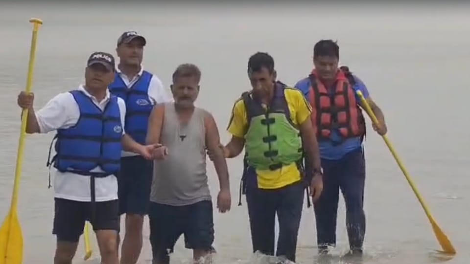 Rishikesh News Man swept into Ganges after slipping amidst rain trapped in marshy islet SDRF saved