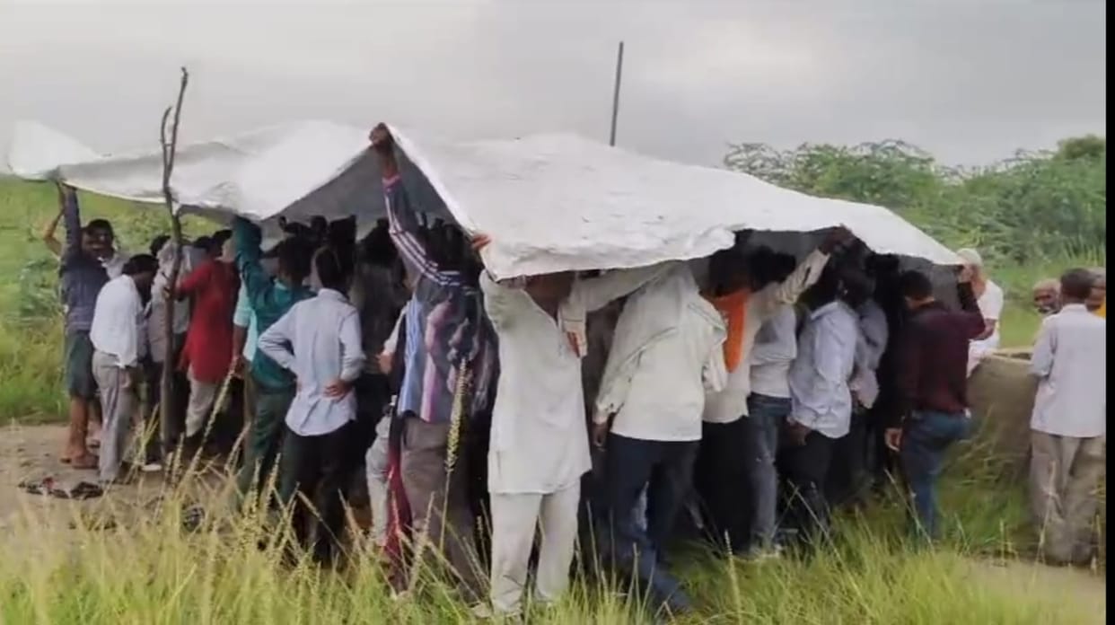 Funeral Performed Under Tarpaulin Amid Rain Villagers Protest Lack of Shed at Cremation Ground