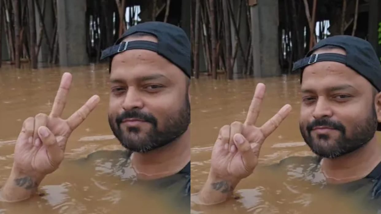 gujarat flood bank employee viral video valsa drain water society office neck deep water