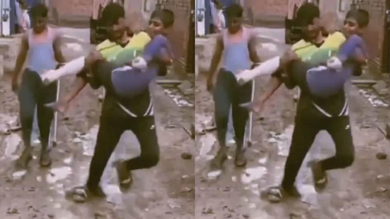 Man Tries to Carry Injured Boy Slips Twice on Muddy Path Viral Video Sparks Reactions