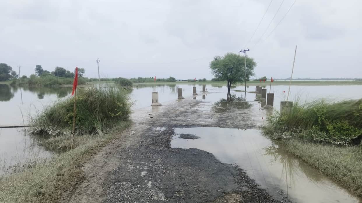 Ganga river water level rises water spills onto the main road of Jata village in Budaun