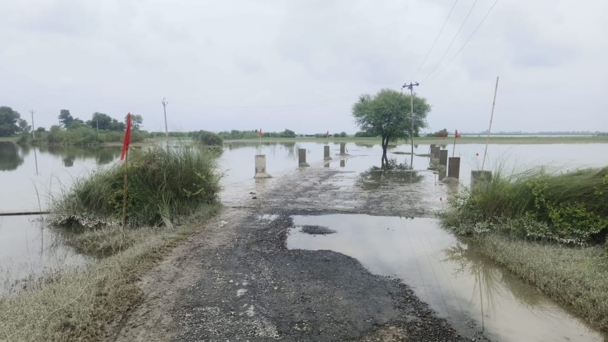 Ganga river water level rises water spills onto the main road of Jata village in Budaun