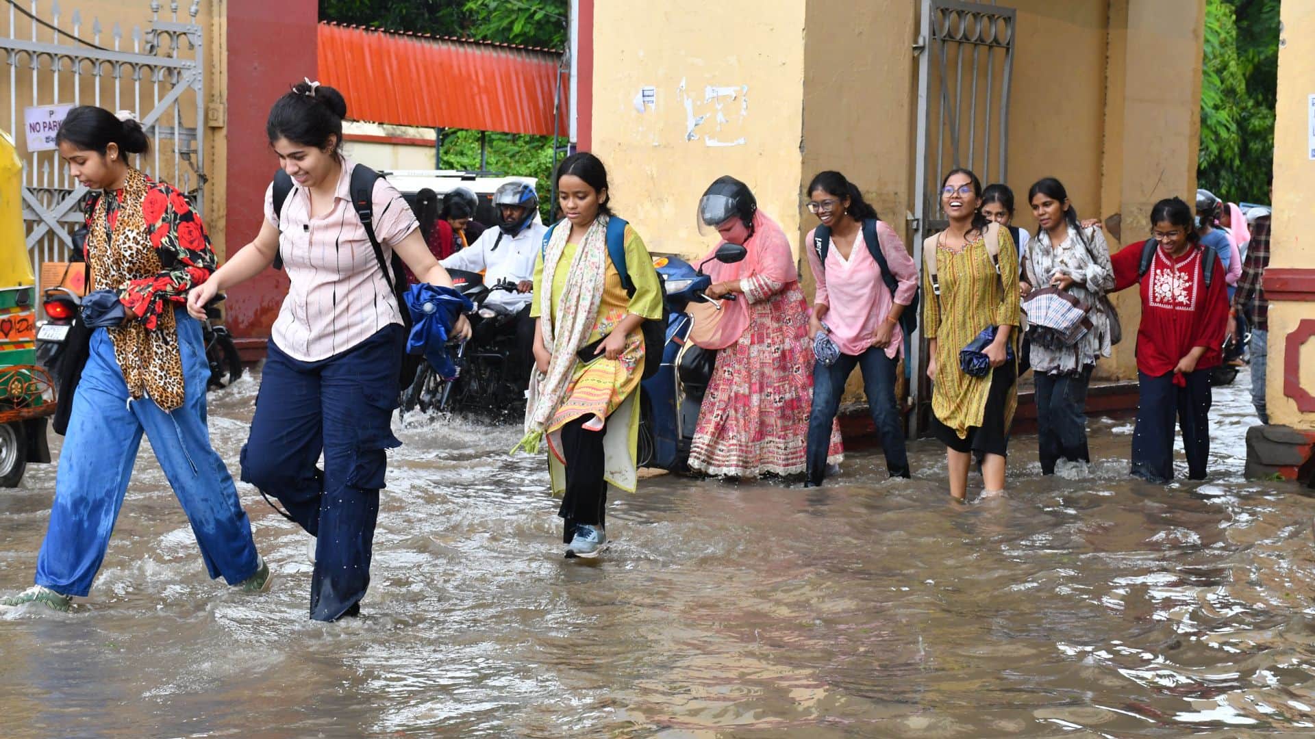 वाराणसी में बारिश के बाद जलभराव के बीच निकलतीं बीएचयू की छात्राएं