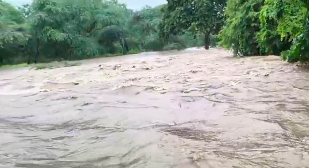 Rain havoc in Mahoba Seeho Nala overflows cutting off six villages villagers risking their lives to cross